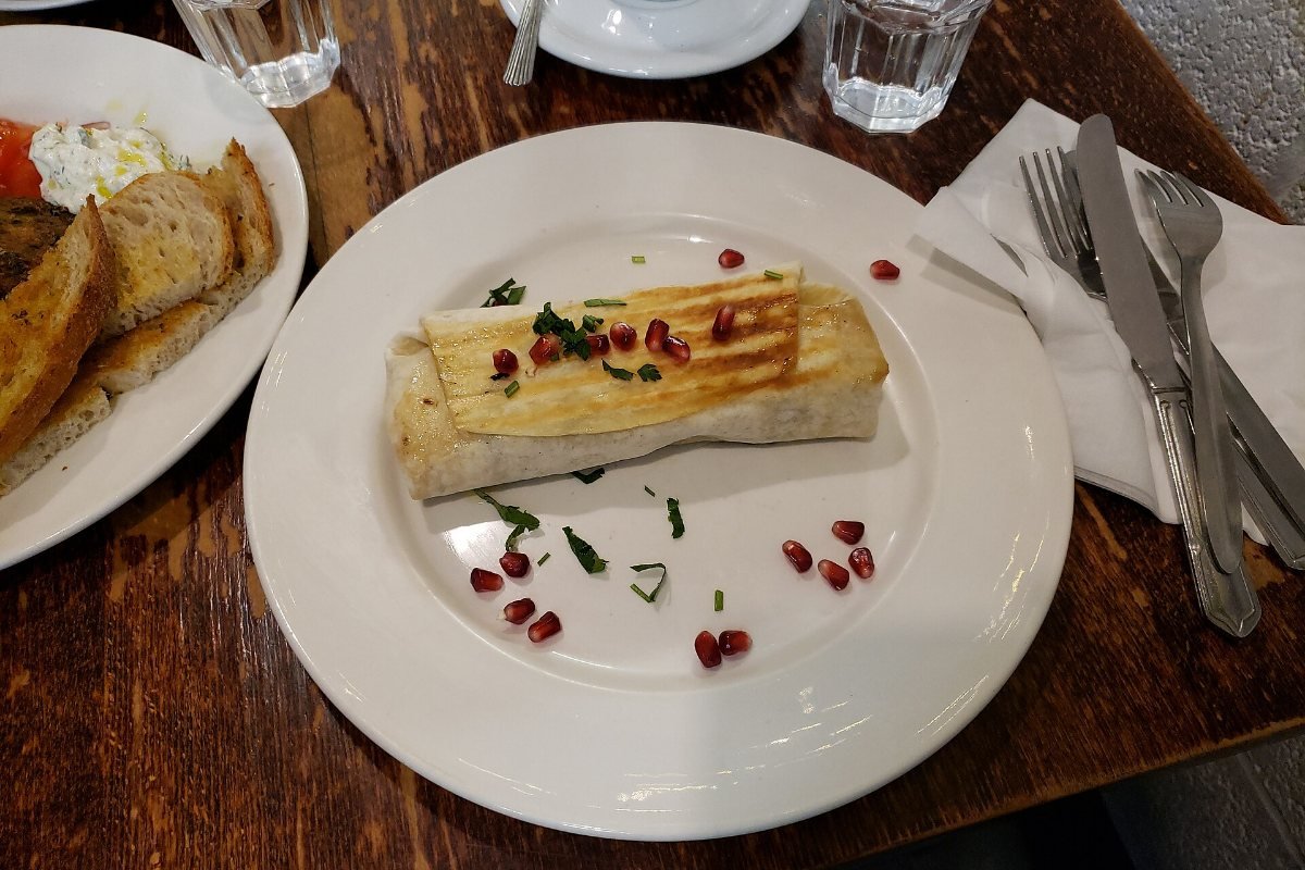 A wrap filled with salad and meat.