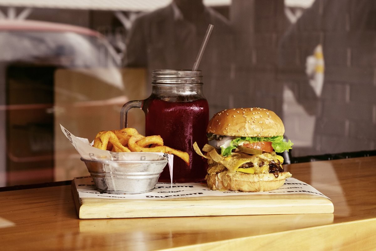 A burger with fries on a table.