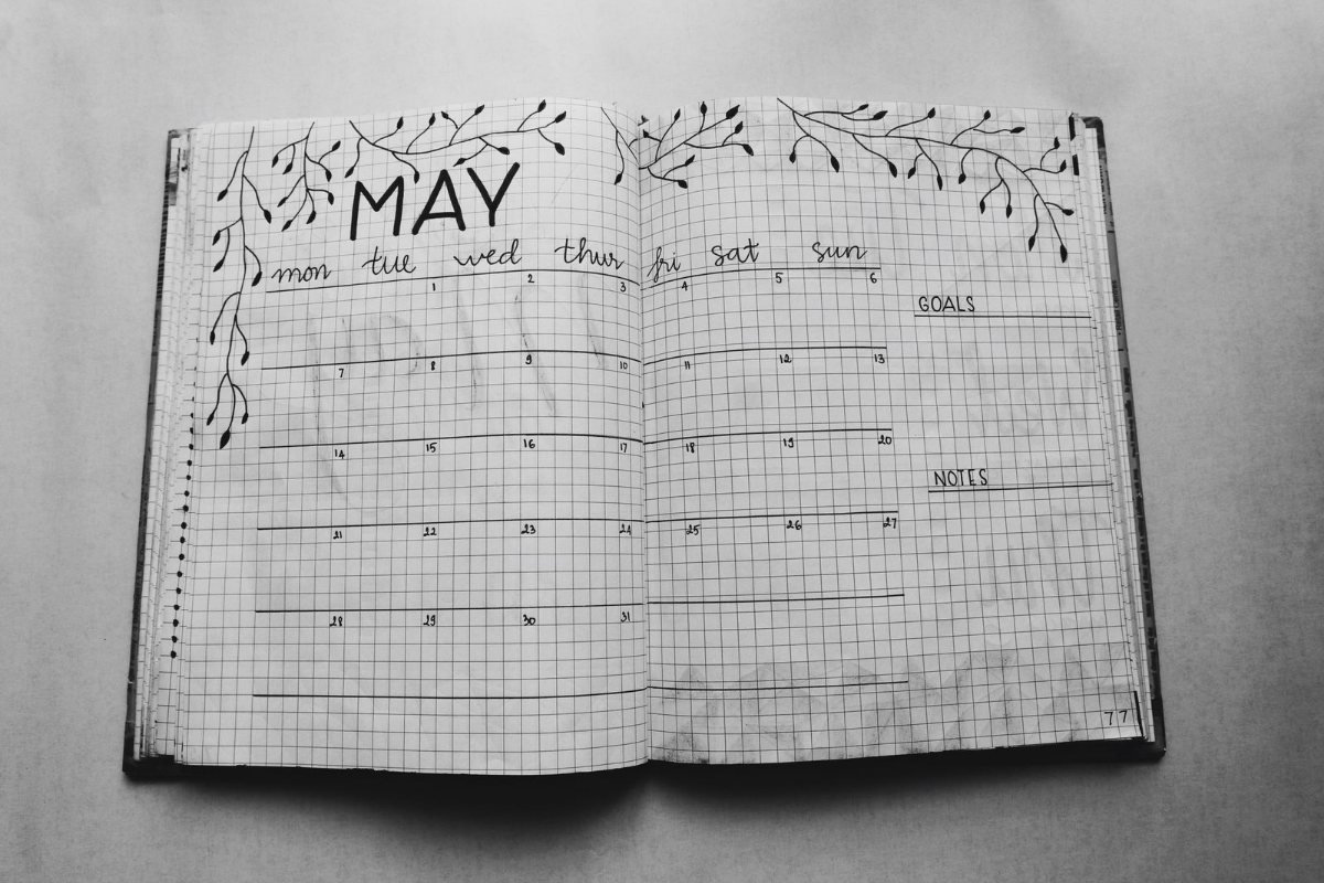 An open planner showing a month grid.