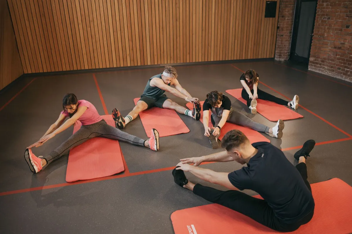 Adults stretching together during a studio class.